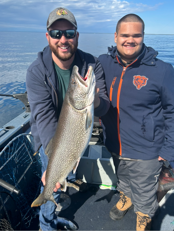 Charter fishing on Lake Michigan — anglers with a caught fish